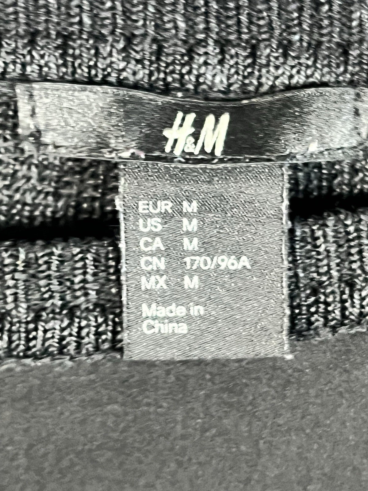 H&M black long-sleeved shirt with a shiny front panel and ribbed sleeves M 